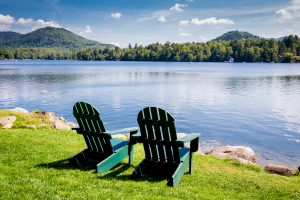 two chairs overlook a quiet lake encouraging government program managers to take a strategy offsite.