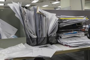 many documents on office desk: messy desk