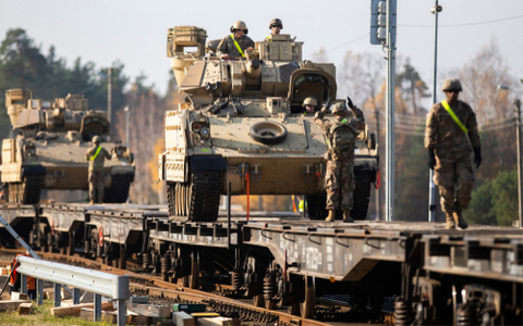 U.S. Army soldiers attend to the logistics of transporting equipment while deployed overseas